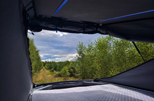 Pop top roof with a tent and a bed